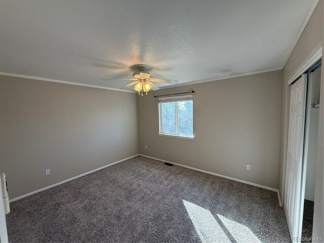 13031 Dexter St, Thornton, CO 80241 - unfurnished bedroom featuring carpet floors, baseboards, ornamental molding, a ceiling fan, and a closet