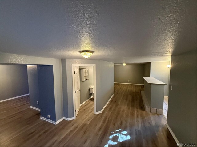 13031 Dexter St, Thornton, CO 80241 - corridor featuring a textured ceiling, wood finished floors, and baseboards