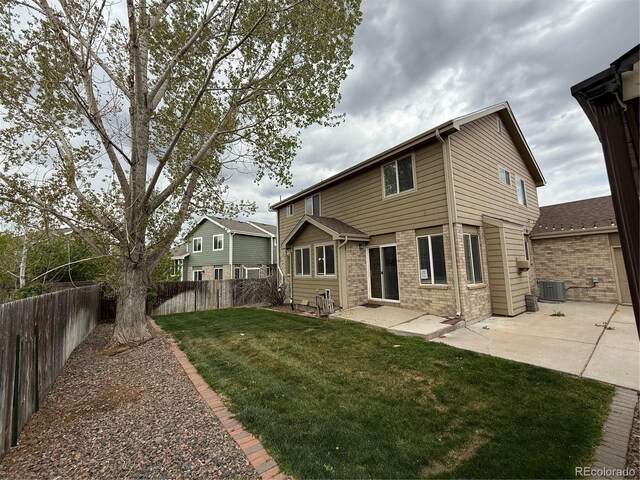 13031 Dexter St, Thornton, CO 80241 - back of property with a patio area, brick siding, and central AC unit
