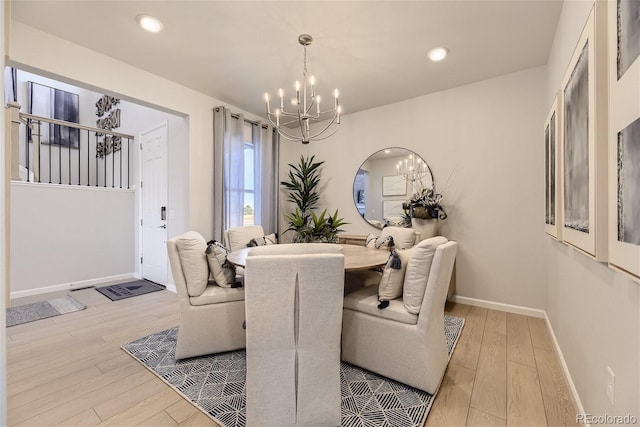 dining area with recessed lighting, baseboards, an inviting chandelier, and wood finished floors