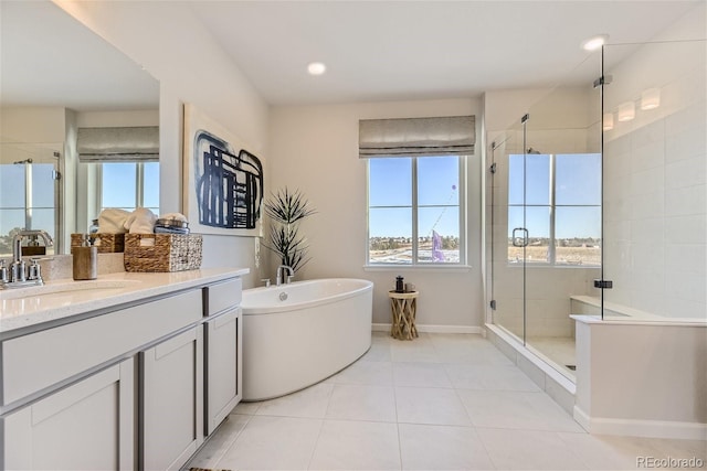 bathroom featuring tile patterned flooring, a soaking tub, a stall shower, and vanity