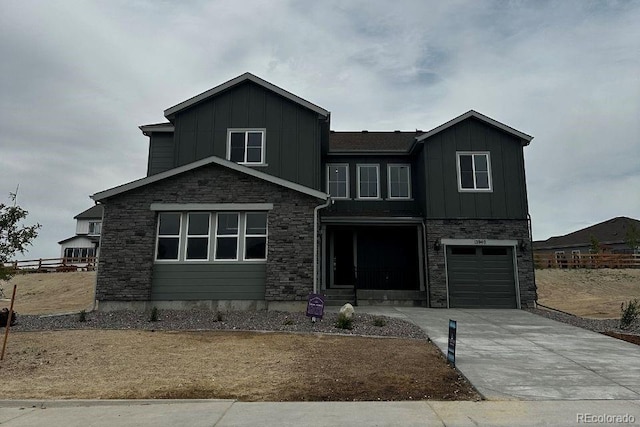 13940 Hanging Lake St, Parker, CO 80138 - view of front of home featuring board and batten siding, stone siding, driveway, and an attached garage