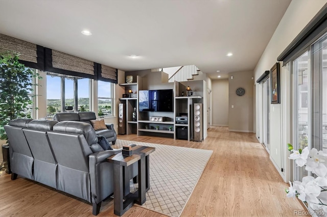 living area featuring recessed lighting, light wood-style flooring, and baseboards