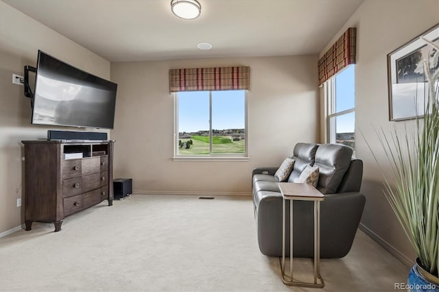 sitting room featuring baseboards and carpet flooring