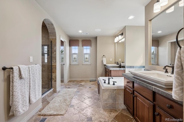 full bathroom with stone tile flooring, a garden tub, visible vents, recessed lighting, and a stall shower