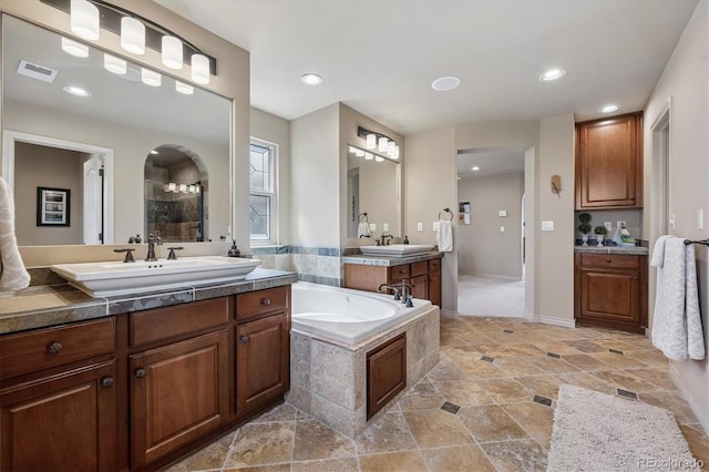 full bathroom featuring a garden tub, a sink, visible vents, and recessed lighting