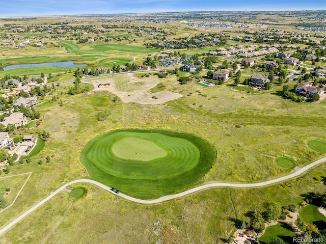 drone / aerial view featuring a water view, golf course view, and a residential view