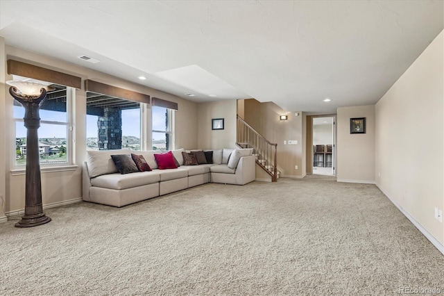 carpeted living room with stairway, baseboards, visible vents, and recessed lighting