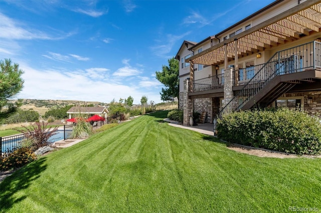 view of yard with stairs and a deck