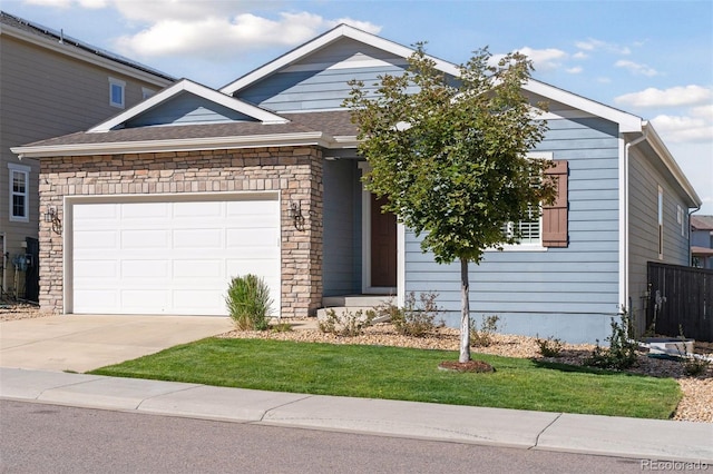 view of front of property with a garage and a front lawn