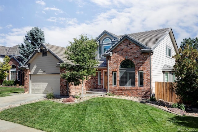 view of front of property featuring a front yard and a garage