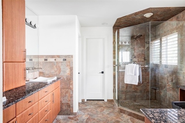 bathroom featuring tile walls, vanity, and an enclosed shower