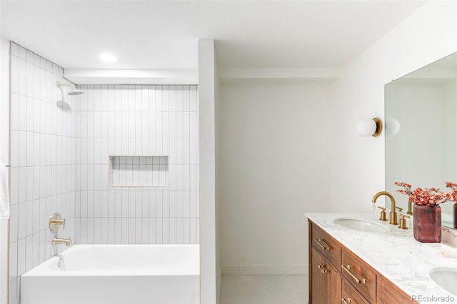 bathroom featuring tile patterned floors, vanity, and tiled shower / bath