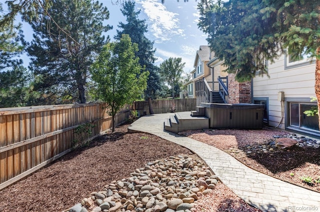 view of yard featuring a patio and a hot tub