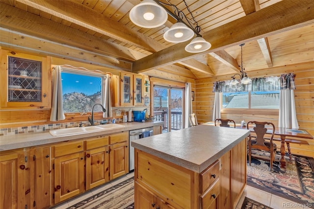 kitchen featuring sink, wood ceiling, a center island, stainless steel dishwasher, and beamed ceiling