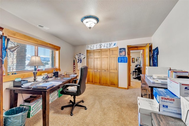 office with light carpet and a textured ceiling