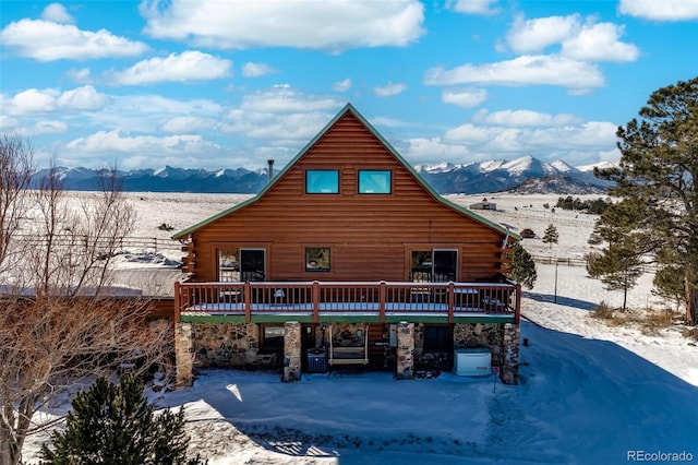 exterior space featuring a deck with mountain view