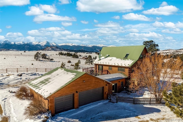 snowy aerial view featuring a mountain view