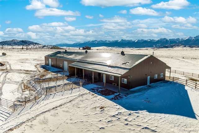 snowy aerial view featuring a mountain view