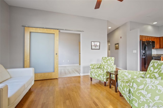 living room with baseboards, light wood finished floors, a ceiling fan, and recessed lighting