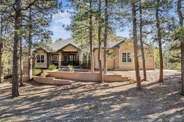 view of front of property with stucco siding and a tile roof