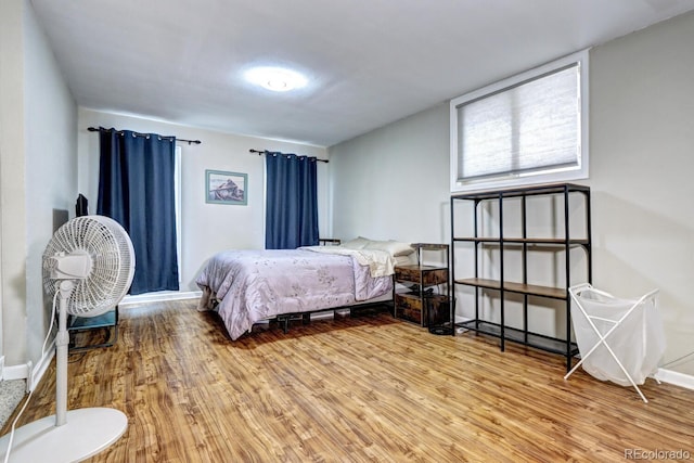 bedroom with baseboards and light wood-type flooring