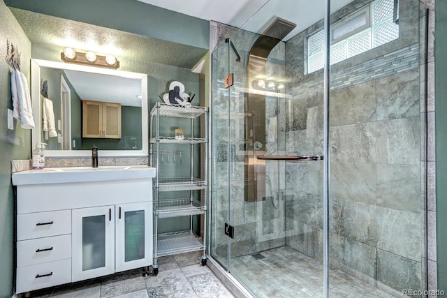 full bathroom featuring vanity and a shower stall