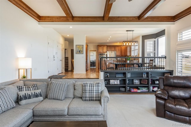 living room featuring recessed lighting, light carpet, a notable chandelier, stairs, and beam ceiling