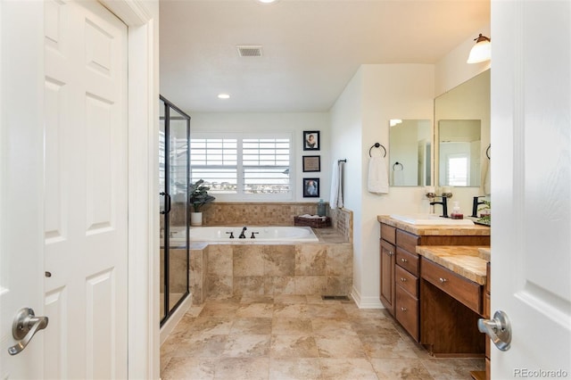 bathroom with a garden tub, vanity, visible vents, and a shower stall