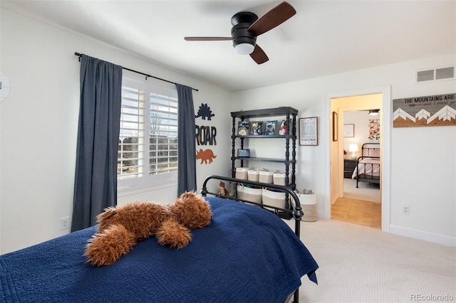 carpeted bedroom featuring ceiling fan, visible vents, and baseboards