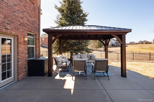 view of patio / terrace with fence, an outdoor living space, and a gazebo