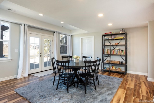 dining room with french doors, visible vents, baseboards, and wood finished floors