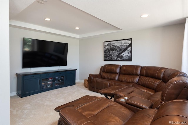 living area featuring a tray ceiling, light colored carpet, baseboards, and recessed lighting