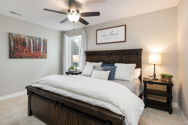 bedroom featuring baseboards, ceiling fan, visible vents, and light colored carpet