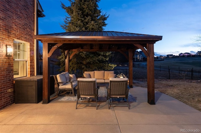 view of patio / terrace with fence, an outdoor living space, and a gazebo