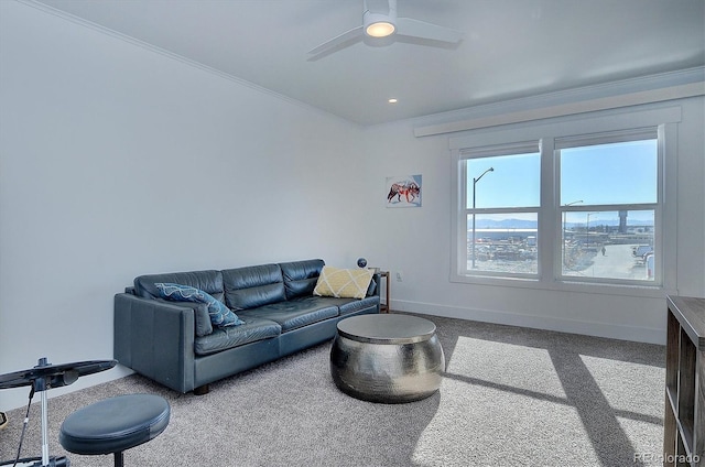 carpeted living room featuring ceiling fan and crown molding