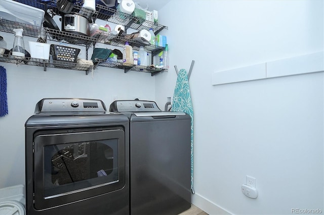 laundry area featuring hardwood / wood-style flooring and independent washer and dryer