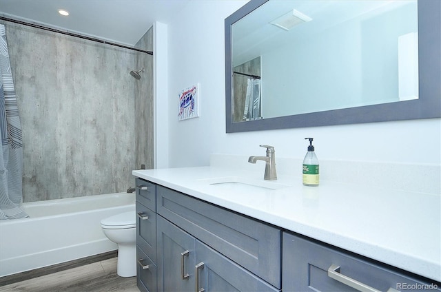 full bathroom with hardwood / wood-style flooring, vanity, toilet, and shower / tub combo with curtain