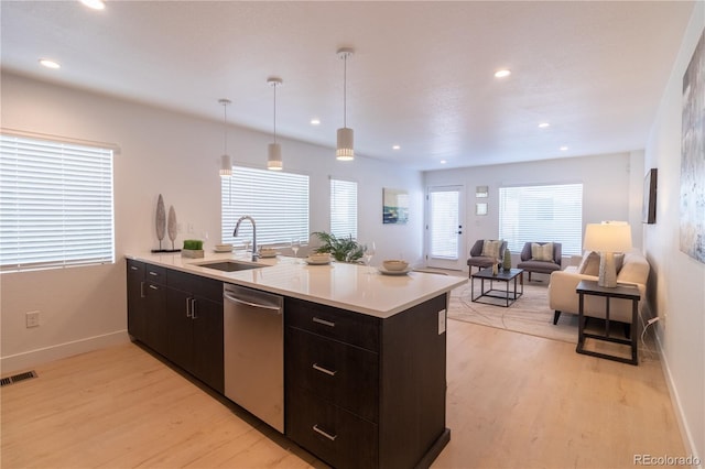 kitchen with sink, decorative light fixtures, light hardwood / wood-style flooring, and stainless steel dishwasher