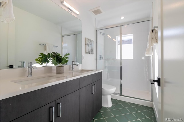 bathroom with vanity, tile patterned floors, toilet, and walk in shower