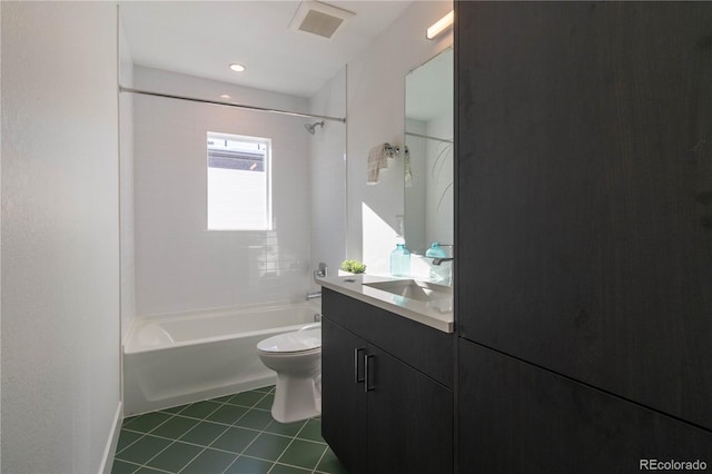 full bathroom featuring vanity, tiled shower / bath combo, tile patterned floors, and toilet