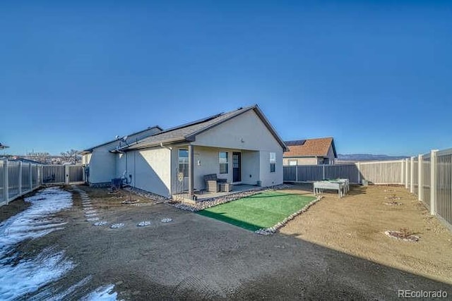 336 Arrowhead Dr, Florence, CO 81226 - back of house featuring stucco siding, a fenced backyard, and a patio