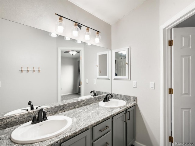 full bathroom with double vanity and a sink