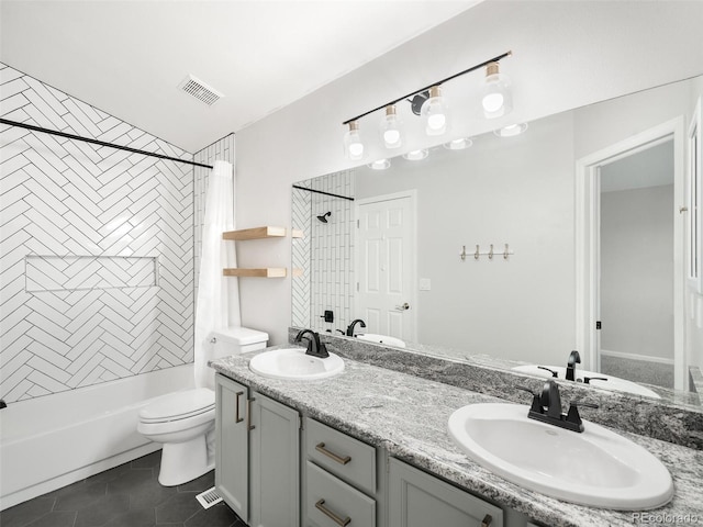 bathroom with shower / tub combo, a sink, visible vents, and tile patterned floors