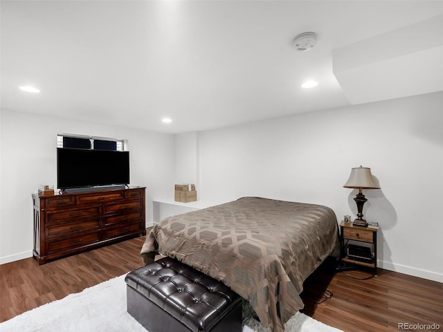 bedroom with recessed lighting, baseboards, and wood finished floors