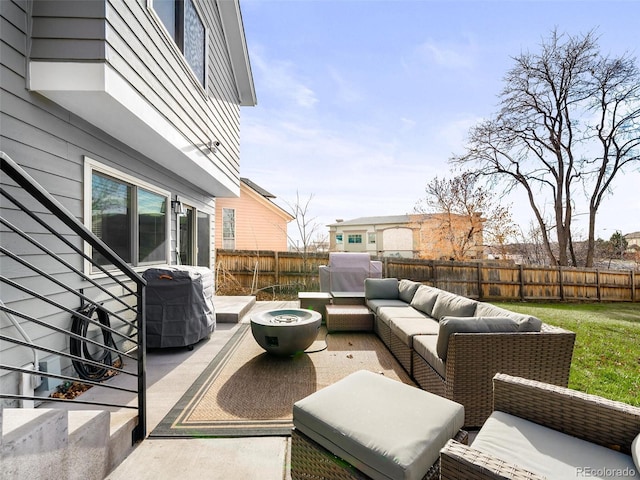 view of patio / terrace featuring a grill, a fenced backyard, and an outdoor living space with a fire pit