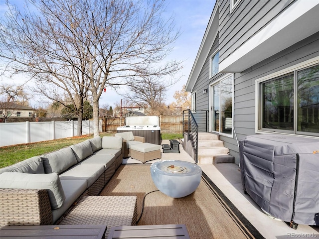 wooden deck with an outdoor hangout area, a patio area, a fenced backyard, and a grill