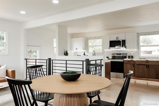 1617 S Quitman St, Denver, CO 80219 - dining area with light wood-type flooring and recessed lighting