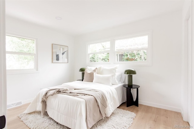 1617 S Quitman St, Denver, CO 80219 - bedroom featuring light wood finished floors and baseboards
