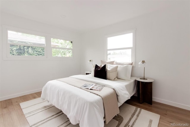1617 S Quitman St, Denver, CO 80219 - bedroom featuring multiple windows, light wood-type flooring, and baseboards